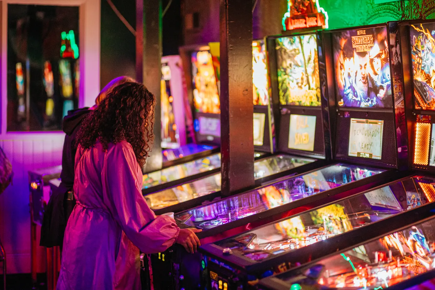 Friends playing pinball at Stella's